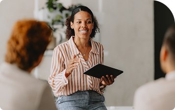 Une femme qui discute avec une tablette dans les mains.
